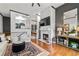 Elegant living room features hardwood floors, a fireplace, and an open view into the kitchen and dining areas at 4248 River Green Dr # 305, Atlanta, GA 30327