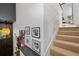 Staircase with carpeted treads, white walls with art, and black railings lead to a landing area with doorway at 4248 River Green Dr # 305, Atlanta, GA 30327
