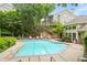 Sparkling outdoor pool with lounge seating and landscaped surroundings, offering a serene and refreshing leisure area at 4248 River Green Dr # 305, Atlanta, GA 30327