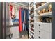 Organized walk-in closet featuring shelving with folded clothes, handbags, and shoes at 4248 River Green Dr # 305, Atlanta, GA 30327