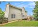 View of the backyard with a well-maintained lawn, a wooden deck, and mature trees providing shade and privacy at 5821 Saint Miles Drive Dr, Buford, GA 30518