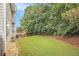 A lush green backyard with a well-maintained lawn and a wooden deck, perfect for outdoor relaxation and entertainment at 5821 Saint Miles Drive Dr, Buford, GA 30518
