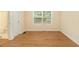 Bedroom with hardwood floors and a view to the bathroom, providing comfort and convenience at 5821 Saint Miles Drive Dr, Buford, GA 30518