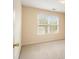 Carpeted bedroom with a large window and neutral walls at 5821 Saint Miles Drive Dr, Buford, GA 30518