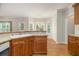 Bright breakfast nook featuring wood floors, a chandelier, and multiple windows overlooking the backyard at 5821 Saint Miles Drive Dr, Buford, GA 30518