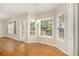 Sunlit breakfast nook with wood floors and multiple windows, perfect for enjoying morning meals at 5821 Saint Miles Drive Dr, Buford, GA 30518