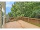 An outdoor wooden deck offers space to enjoy nature at 5821 Saint Miles Drive Dr, Buford, GA 30518
