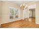 Elegant dining room with hardwood floors, chandelier, and natural light at 5821 Saint Miles Drive Dr, Buford, GA 30518