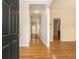 Inviting hallway featuring hardwood floors and neutral paint, offering a glimpse of the home's layout at 5821 Saint Miles Drive Dr, Buford, GA 30518