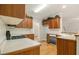 Well-lit kitchen featuring wood cabinets, laminate counters, wood flooring, and modern appliances at 5821 Saint Miles Drive Dr, Buford, GA 30518