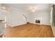 Bright and airy living room featuring hardwood floors, a fireplace, and access to the stairs at 5821 Saint Miles Drive Dr, Buford, GA 30518