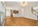 Open-concept living room with gleaming hardwood floors and access to the kitchen and staircase at 5821 Saint Miles Drive Dr, Buford, GA 30518