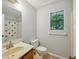 Bathroom with decorated shower and a window with outdoor view at 1925 Sailcloth St, Lithonia, GA 30058