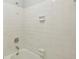 A tiled bathtub and shower combination with shower head at 1925 Sailcloth St, Lithonia, GA 30058