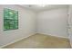 A bedroom with carpeted floors and a window with natural light at 1925 Sailcloth St, Lithonia, GA 30058