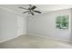 Neutral-colored bedroom with carpet and a window at 1925 Sailcloth St, Lithonia, GA 30058
