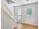 Entryway with hardwood floors, staircase, and white door at 1925 Sailcloth St, Lithonia, GA 30058