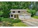 Traditional two-story home with a two-car garage and an expansive front lawn at 1925 Sailcloth St, Lithonia, GA 30058