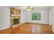A living room with a wood floor and stone fireplace at 1925 Sailcloth St, Lithonia, GA 30058