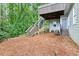 View of backyard with walkout basement and stairwell at 2220 Cape Courage Way, Suwanee, GA 30024