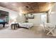 Finished basement with sleeping area featuring a queen bed, side tables, and entertainment center at 2220 Cape Courage Way, Suwanee, GA 30024