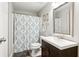 Bathroom with vanity sink, toilet and tub-shower combination with tile surround and decorative shower curtain at 2220 Cape Courage Way, Suwanee, GA 30024