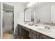 Well-lit bathroom with a dual sink vanity, a large mirror, and a separate shower and tub area at 2220 Cape Courage Way, Suwanee, GA 30024
