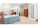 Cozy bedroom has double doors and neutral colors, offering a comfortable space at 2220 Cape Courage Way, Suwanee, GA 30024