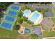 Aerial view of community amenities including tennis courts, swimming pool, playground, and parking at 2220 Cape Courage Way, Suwanee, GA 30024