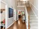 Spacious foyer featuring hardwood floors and a staircase leading to the second floor at 2220 Cape Courage Way, Suwanee, GA 30024