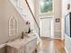 Bright foyer features hardwood floors, a staircase, and a view of the front door at 2220 Cape Courage Way, Suwanee, GA 30024