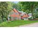 Charming two-story brick home featuring a manicured lawn and attached two-car garage at 2220 Cape Courage Way, Suwanee, GA 30024