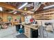 Spacious garage with wood-paneled walls, multiple work benches, ample lighting, and storage shelves at 2220 Cape Courage Way, Suwanee, GA 30024