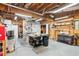 Spacious garage with wood-paneled walls, multiple work benches, storage shelves, and industrial equipment at 2220 Cape Courage Way, Suwanee, GA 30024