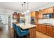 Spacious kitchen with granite countertops, stainless steel appliances, and a center island with seating at 2220 Cape Courage Way, Suwanee, GA 30024