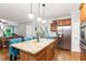 Open concept kitchen with granite counters, stainless appliances, and a large center island at 2220 Cape Courage Way, Suwanee, GA 30024