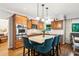 Modern kitchen with granite countertops, stainless steel appliances, and a center island with seating at 2220 Cape Courage Way, Suwanee, GA 30024