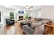 Spacious living room has a fireplace, hardwood floors, and ample natural light at 2220 Cape Courage Way, Suwanee, GA 30024