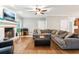 Bright living room with a fireplace, hardwood floors, and a comfortable sectional sofa at 2220 Cape Courage Way, Suwanee, GA 30024