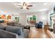 Open-concept living room with hardwood floors, fireplace, and view into kitchen and dining area at 2220 Cape Courage Way, Suwanee, GA 30024