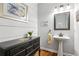 Stylish powder room boasting shiplap walls, modern vanity, and chic decor for a sophisticated touch at 2220 Cape Courage Way, Suwanee, GA 30024