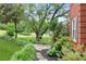 Landscaped side yard with stone pathway leading to an outdoor seating area at 2220 Cape Courage Way, Suwanee, GA 30024