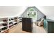 Walk-in closet with shelves, an island, a window, and chair with a patterned quilt draped over it at 2220 Cape Courage Way, Suwanee, GA 30024
