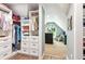 Well-organized walk-in closet with custom shelving and storage solutions, leading to a cozy sitting area at 2220 Cape Courage Way, Suwanee, GA 30024