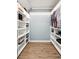 Functional walk-in closet featuring built-in shelving, providing organized storage for clothing and accessories at 2220 Cape Courage Way, Suwanee, GA 30024