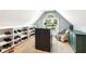 Walk-in closet with shelves, an island, a window, and chair with a patterned quilt draped over it at 2220 Cape Courage Way, Suwanee, GA 30024