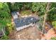 Overhead view of the house showing roof, surrounding trees, and storage shed at 276 Lydia Se Dr, Atlanta, GA 30315