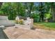 Backyard featuring a white brick patio and mature trees at 276 Lydia Se Dr, Atlanta, GA 30315