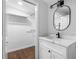 Bright bathroom with a vanity, mirror, and a view into a walk-in closet at 276 Lydia Se Dr, Atlanta, GA 30315