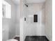 Modern bathroom with tiled shower, dark shower floor, and natural light at 276 Lydia Se Dr, Atlanta, GA 30315